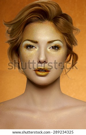 Fashion beauty Female Model with gold Face and Lips