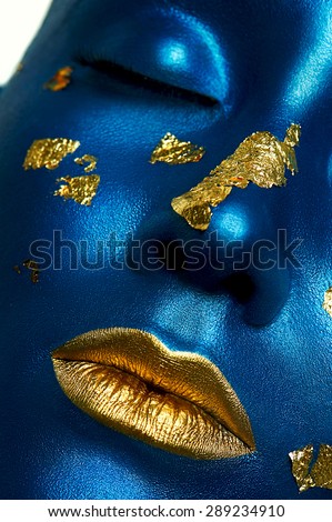 Closeup beauty female Model with blue Skin and gold Lips. Halloween Alien Makeup
