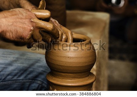 Potter shaping clay on the pottery wheel