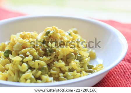 Yellow risotto. Recipe: rice, turmeric, ginger, peas and leek. This is a vegan dish and all ingredients are organic food./Risotto with turmeric, ginger, peas and leek
