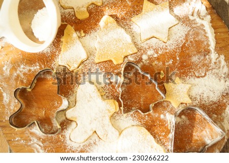 Gingerbread cookies. Making gingerbread cookies. Christmas baking background dough, cookie cutters, spices and nuts. Viewed from above