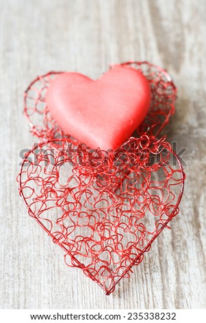 Red Valentine\'s day heart toy. On wooden background with copy space