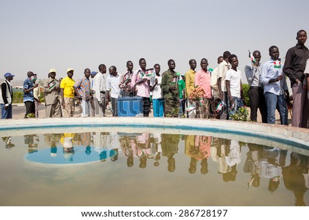 Juba, South Sudan - February 15, 2014: South Sudanese men wait in line to join a Sudan People Liberation Movement rally