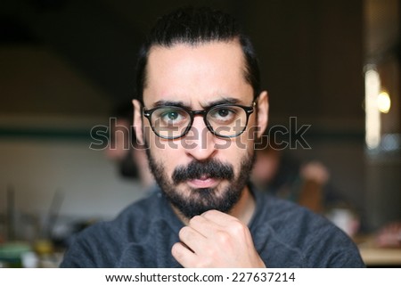 hipster man with glasses suspicion and questioning