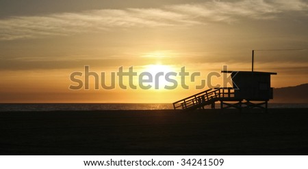 california sunset with life guard station silhouette