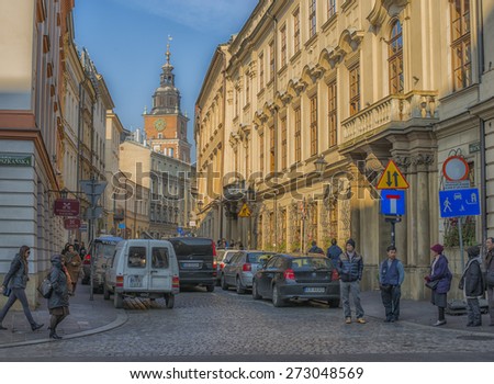 KRAKOW, POLAND - NOV 04, 2014: Walking tourists towards the center of the old town. Architecture and streets of the old city.