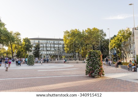 VARNA, BULGARIA - AUG 08, 2015: Tourists walk on a pedestrian street in downtown. Architecture and streets of the town of Varna in Bulgaria. Picture taken during a trip to Bulgaria.