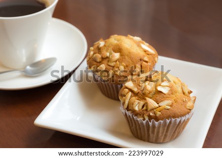Banana cake topping with cashew nut on table with coffee