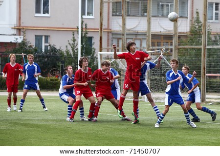 BELGOROD, RUSSIA - AUGUST 21: Unidentified boys plays football on August, 21 2010 in Belgorod, Russia. The final of Chernozemje superiority, Football kinder team of 1996 year of birth.