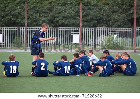 BELGOROD, RUSSIA - AUGUST 20: Unidentified man (coach) with unidentified boys (football players) August, 20 2010 in Belgorod, Russia. The final of Chernozemje superiority, team of 1996 year of birth.