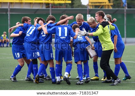 BELGOROD, RUSSIA - AUGUST 20: Unidentified boys embrace before football game on August, 20 2010 in Belgorod, Russia. The final of Chernozemje superiority, Football kinder team of 1996 year of birth.