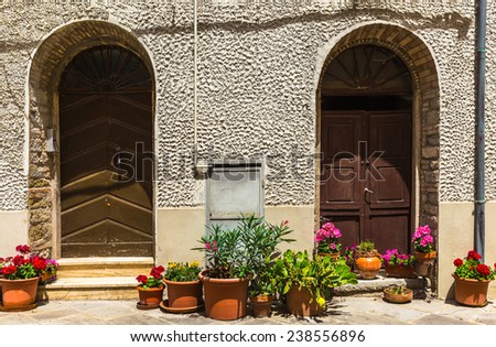 doors decorated with flowers in tuscan village