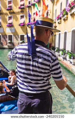 VENICE, ITALY - June 26, 2014: Tourists travel on gondolas in Venice, Italy. Gondola ride is the most popular tourist activities in Venice.