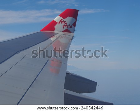 TOKYO, JAPAN - OCTOBER 30: Thai AirAsia X (TAAX) plane\'s wing with logo and Mt.Fuji, the plane flying over Tokyo-Japan to Thailand on October 30 2014. AirAsia as Asia\'s Leading Low Cost Airline.