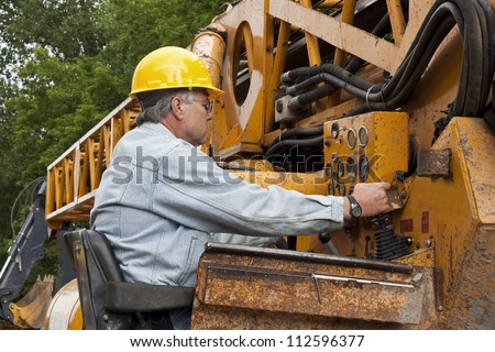 male crane operator getting his equipment ready for the workday