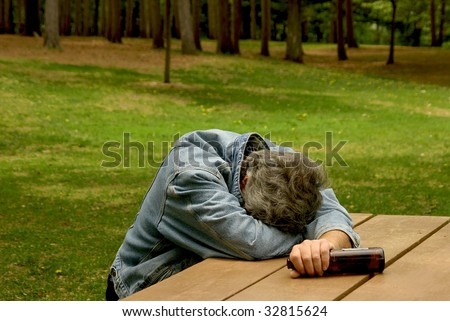 man passed out at picnic bench after drinking alcohol