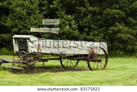 vintage horse drawn manure spreader sitting in a field