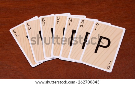 RIVER FALLS,WISCONSIN-MARCH 22,2015: Several Boggles cards on a wood background. These cards are based on the original Boggle game.