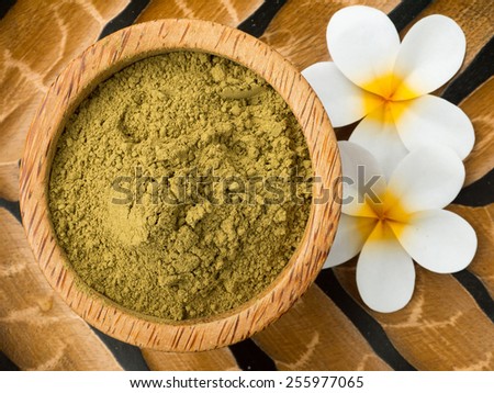 Henna powder in coconut bowl