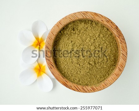 Henna powder in coconut bowl and tiare