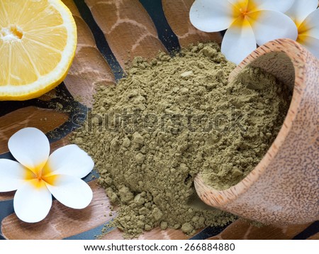 Tiare flowers,lemon and henna powder in coconut bowl