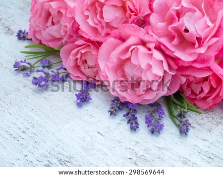 Curly pink roses and lavender bouquet on the white painted rustic background