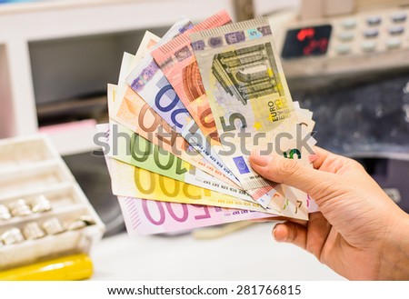 Exchange euro currency,money at counter in the bank branch on colorful banknotes