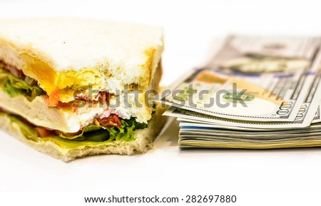 A lot of money for buying food with sandwich and hundred dollars banknotes