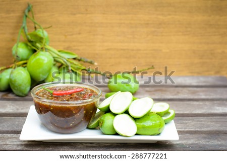 Sour taste with green of fresh mangoes and sweet fish sauce and spicy of Thai snack,Focus on red chili