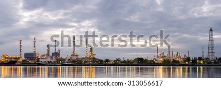 PANORAMA , Sunrise, oil refinery factory industry plant at twilight morning with reflection on the river.