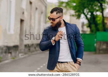 bearded man with e-cigarette outdoors