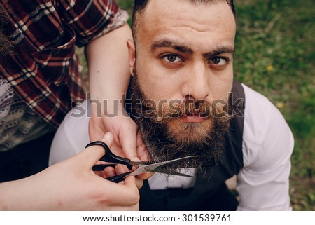 two bearded men shave outdors