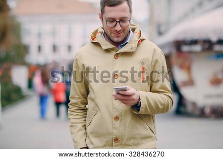 adult man speaks on the phone and writing text