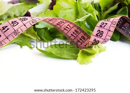 Fresh green salad mix with measure tape