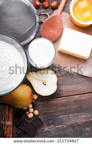 Ingredients and tools for baking sweet cake with chocolate and pears
