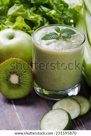 Healthy green smoothie and green vegetables and fruits close-up