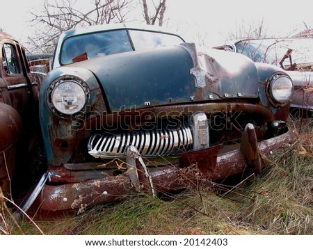 Rusting car in wrecking yard