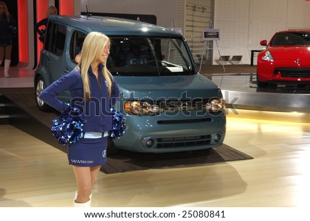 TORONTO, FEBRUARY 11: Nissan Cube with cheerleaders from the Toronto Argonauts Football Club at the Canadian International AutoShow 2009.  More than 1000 cars are trucks are on display at this show