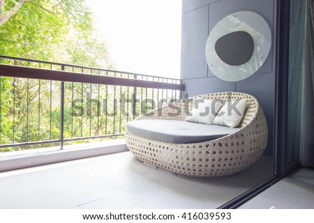 Sofa on the balcony with garden view.