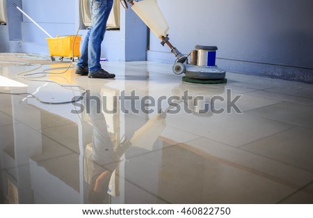 The people cleaning floor with machine.