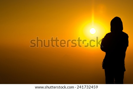silhouette man standing on colorful sun light background