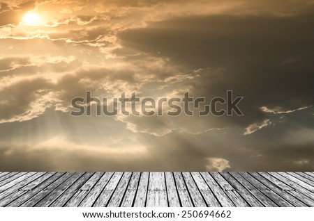 Wood and Beautiful sunset with bright Sun behind clouds.