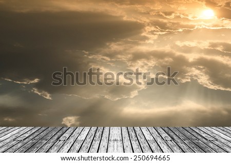 Wood and Beautiful sunset with bright Sun behind clouds.
