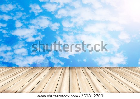 wooden texture floor with sunshine blue sky background