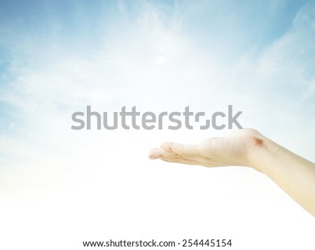 praying hands on sky background