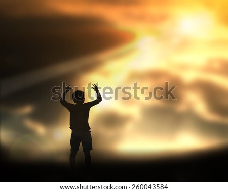 silhouette man praying on cliff with god light and sky and cloud background