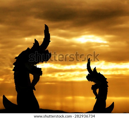 The naga silhouette on sunset nature sky with god light