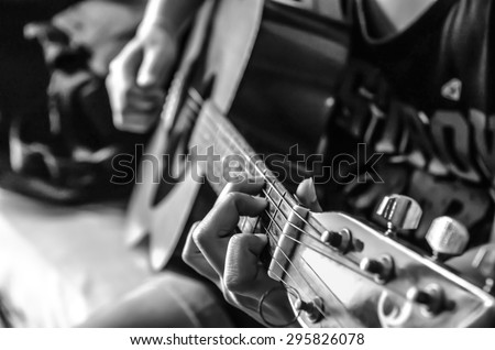 female hand on classical guitar , black and white color