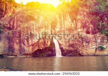 Chattrakan Waterfall in Thailand water fall in deep forest at border of Phitsanulok province Thailand with sun light: soft focus