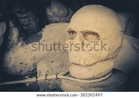 Ancient stone skull and rope Hanged naked